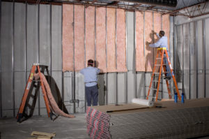 Fiberglass insulation installation in a commercial building.
