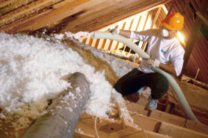 Blown-in fiberglass insulation installed in attic.