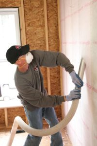 Fiberglass blown insulation installed in a wall.